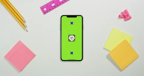 Using green screen phone on a arts and crafts white table Stock Footage 97483553