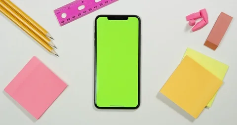 Using green screen phone on a arts and crafts white table Stock Footage 97484930