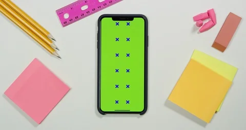 Using green screen phone on a arts and crafts white table Stock Footage 97485528
