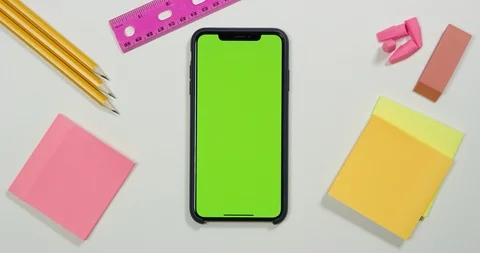 Using green screen phone on a arts and crafts white table Stock Footage 97485930