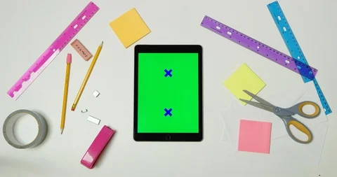 Using green screen tablet on a arts and crafts white table Stock Footage 97479757