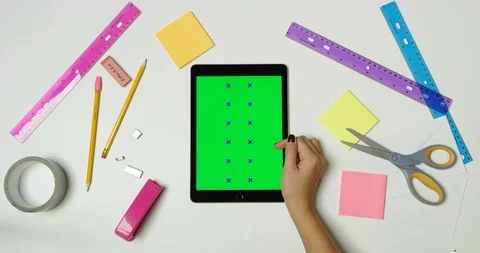 Using green screen tablet on a arts and crafts white table Stock Footage 97480549