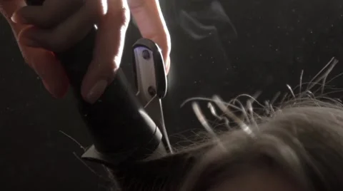 Using hair iron in slow motion Stock Footage 67860963