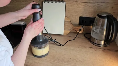 Using a Hand Blender to Mix Ingredients in the Kitchen Stock Footage 305750375