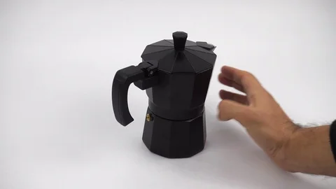 Using hand to close open the top and rotate a stovetop expresso coffee Stock Footage 101396581