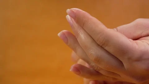 Using hand cream for dry skin close-up moisturizing palms and treating Stock Footage 263744656