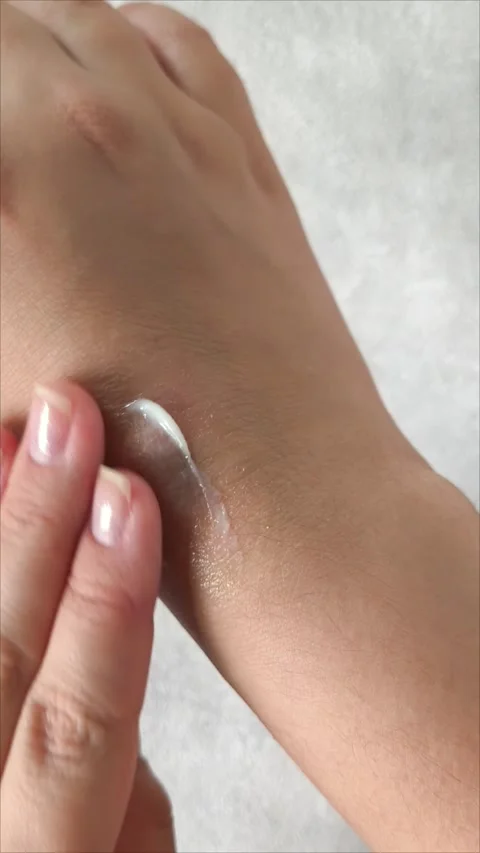 Using hand cream for dry skin close-up moisturizing palms and treating Stock Footage 313653204