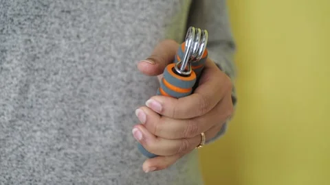 Using hand grippers for strength training at home Stock Footage 337334516