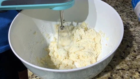 Using a hand mixer to make homemade icing Stock Footage 94539779