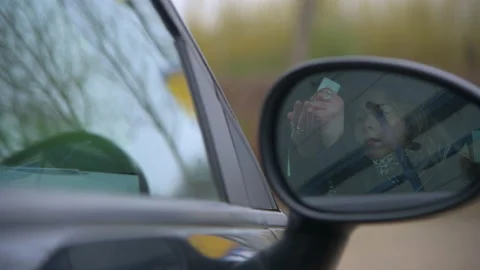 Using Hand Sanitiser in Car Mirror Stock Footage 153100151