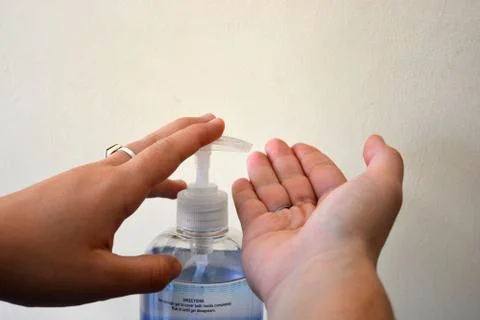 Using hand sanitiser Stock Photos
