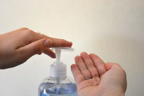 Using hand sanitiser Stock Photos