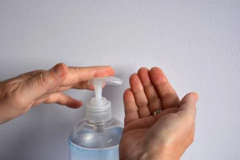 Using hand sanitiser Stock Photos