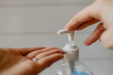 Using Hand Sanitizer to fight covid-19 Stock Photos