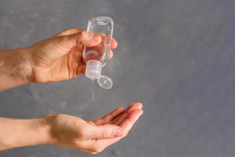 Using hand sanitizer on grey background Stock Photos
