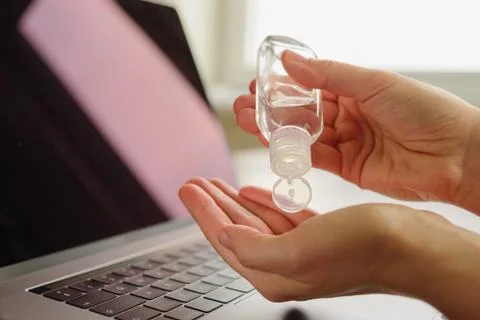 Using Hand sanitizer on working desk Stock Photos