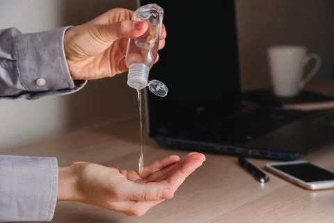Using Hand sanitizer on working table Stock Photos
