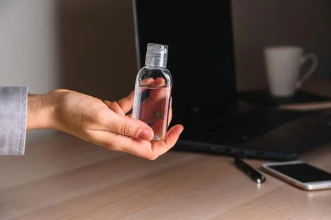 Using Hand sanitizer on working table Stock Photos