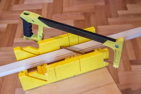 Using hand saw and miter box Stock Photos