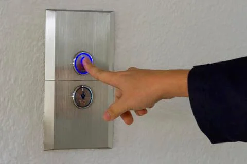 Using hands, press the elevator up and keypad elevator Stock Photos