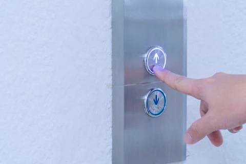 Using hands, press the elevator up and keypad elevator Stock Photos