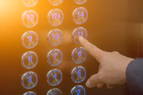 Using hands, press the elevator up and keypad elevator Stock Photos