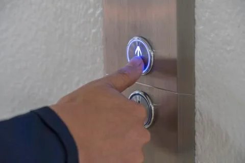 Using hands, press the elevator up and keypad elevator Stock Photos