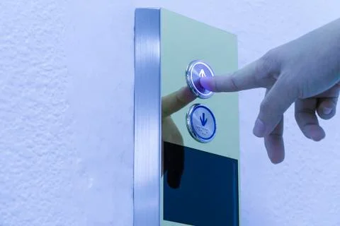 Using hands, press the elevator up Stock Photos
