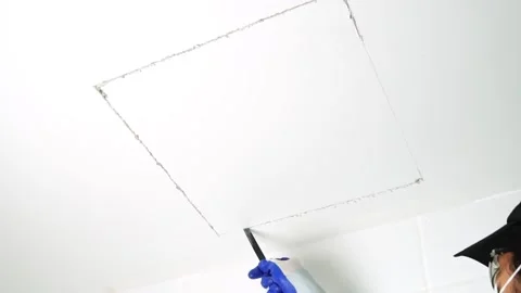 Using a handsaw cutting to cut a hole in the ceiling to install the service port 스톡 동영상 232214998