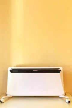 Using heater at home in winter. Heating season. Modern Electric Heater with c Stock Photos