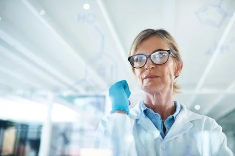 Using her knowledge to make successful predictions. a mature scientist drawing Stock Photos