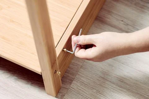 Using hex key when assembling flat pack furniture. Stock Photos