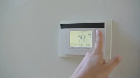 Using home thermostat regulate temperature Stock Footage 320030153