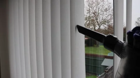 Using hoover vacuum to clean window blinds Video stock 146446201