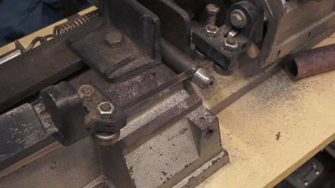 Using a horizontal bandsaw cutting a metal bar Stock Footage 274920776