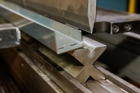 Using the hydraulic machine for metal bending, sheet metal will be bent on the Stock Photos