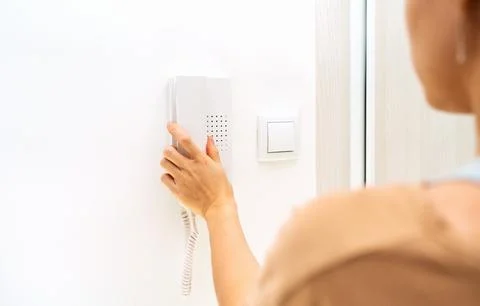 Using of intercom device at home. Stock Photos
