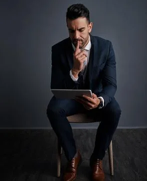 Using the internet for business efficiency. Studio shot of a stylish young Stock Photos