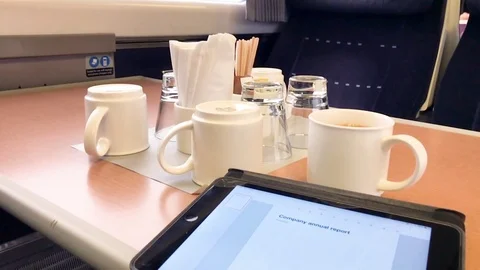 Using an Ipad to write a business report in a first class train carriage Stock Footage 101821130