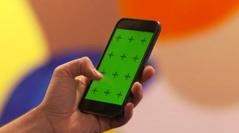 Using iPhone 6 in Front of Colorful Wall Green Screen Video stock 46077164