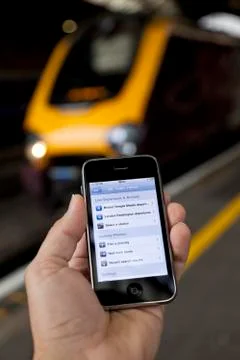 Using iphone to plan a train journey Stock Photos