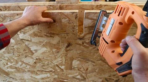 Using a jigsaw to cut a recess in an OSB sheet Stock Photos