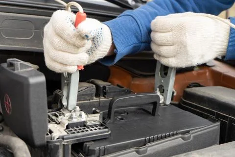 Using jumper cables to charge the car battery. Stock Photos