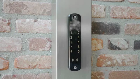 Using key pad on futuristic touchscreen lock, typing code to open door, 스톡 동영상 135076146