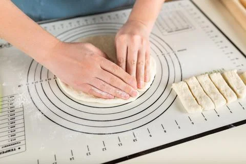 Using the kitchen silicone baking mat in the cooking process Stock Photos