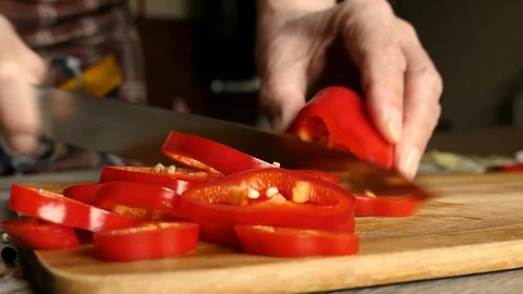 Using Knife To Cutting Ramiro Red Hot Pepper On Cutting Wooden Board. Top View.  Stock Footage 128708550