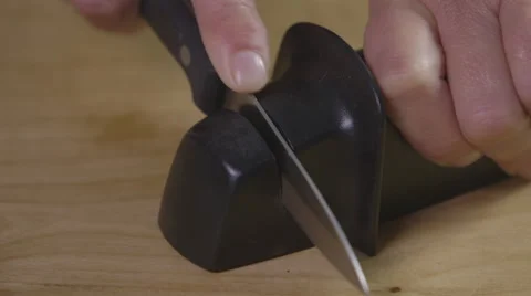 Using a knife sharpener Stock Footage 64029375