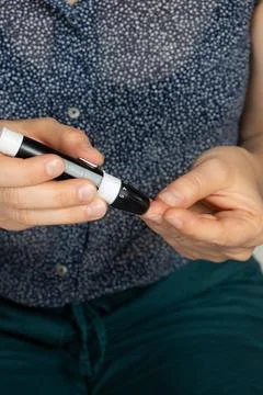 Using lancet device to prick finger for blood sugar test close up Stock Photos