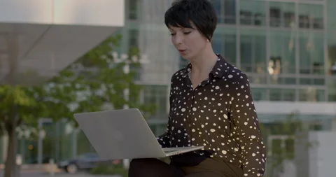 Using laptop with artificial intelligence, businesswoman engages in remote work. Stock Footage 275855747