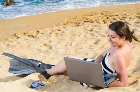 Using laptop on beach Stock Photos